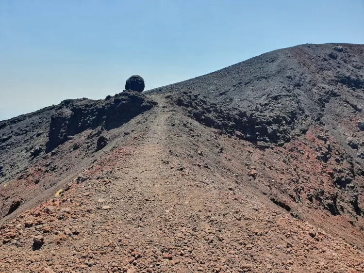 A lava bomb on the rim of a 2002 crater